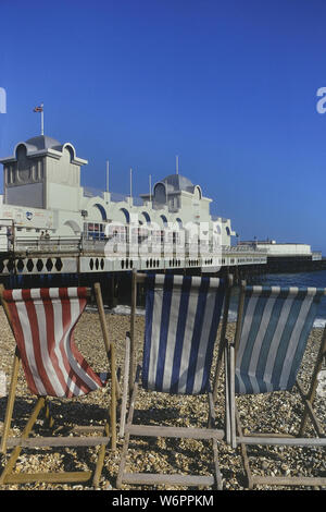 Beach deckchairs in front of the South Parade Pier, Southsea, Portsmouth, Hampshire, England, UK. Circa 1980's Stock Photo