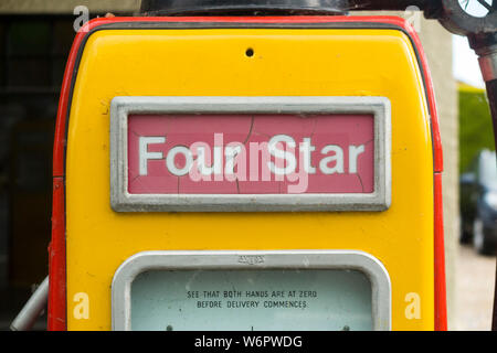 An old classic and obsolete Shell four star pump / vintage 4 star petrol pumps at filling station garage forecourt. UK. (110) Stock Photo