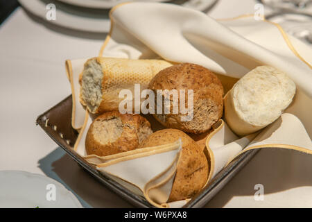 Bread Basket on Set Kitchen Table with butter Stock Photo