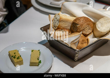 Bread Basket on Set Kitchen Table with butter Stock Photo