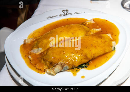 Vegetarian stuffed pasta noodle with red sauce served on top Stock Photo