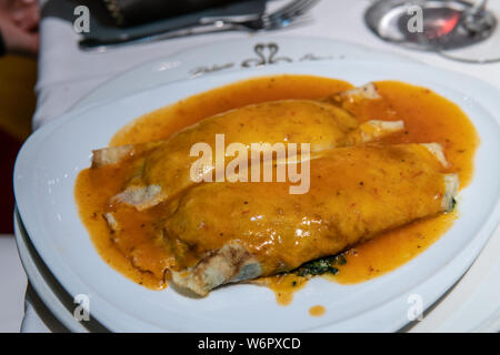 Vegetarian stuffed pasta noodle with red sauce served on top Stock Photo