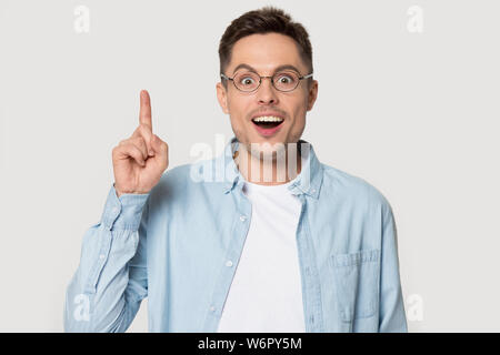 Amazed guy makes big eyes suddenly invented a great idea Stock Photo
