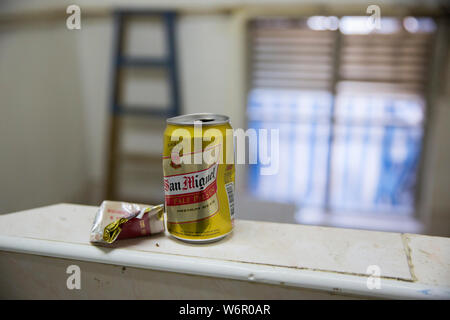 cigarette mansions An empty can of beer and cigarette package lying on the rail of Chungking  Mansions stairs. Hong Kong Stock Photo