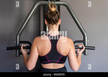 Young athletic woman exercising at the gym. Stock Photo