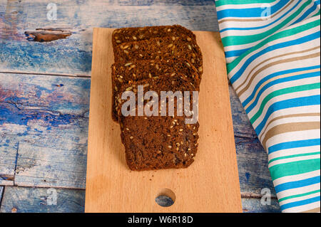 Sliced grain bread on a wooden Board. Lunch in rustic style Stock Photo