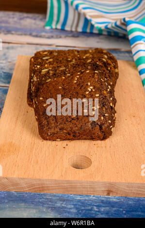 Sliced grain bread on a wooden Board. Lunch in rustic style Stock Photo