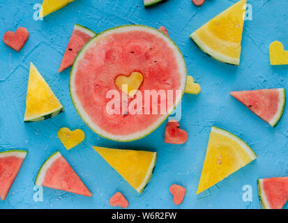 Colored watermelons in pieces with heart figures. Stock Photo