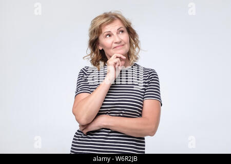 Woman thinking about something making plans about future. Stock Photo