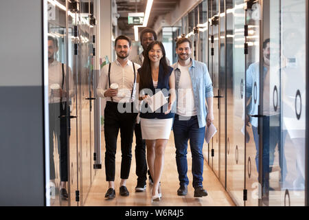 Happy multinational corporate business team stand in office hallway Stock Photo