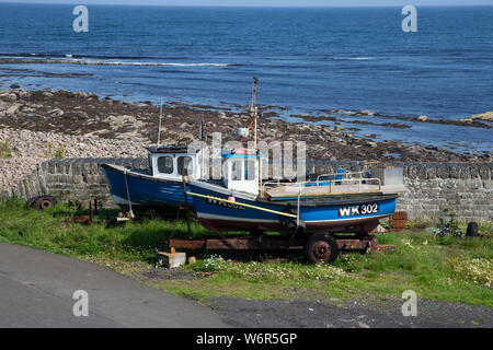 Two abandoned fishing boats in Keiss harbour, Caithness including WK302 that was rescued by the Wick lifeboat in May 2014 when filling with water Stock Photo