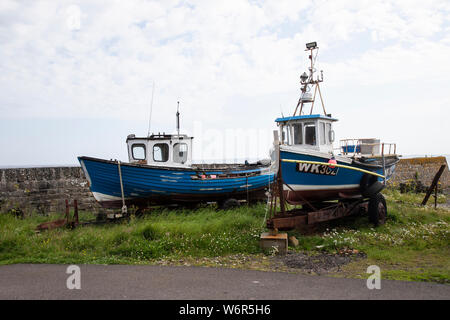 Two abandoned fishing boats in Keiss harbour, Caithness including WK302 that was rescued by the Wick lifeboat in May 2014 when filling with water Stock Photo