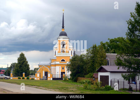 Yuryevo-Devichye, Russia - July 07, 2019: View of the summer village street and the church of St. George built early 19th century. Stock Photo