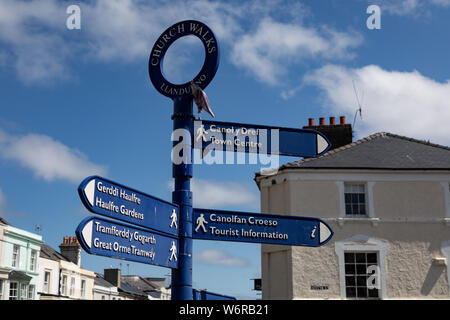 Bilingual street signs for pedestrians in the centre of Llandudno in North Wales May 2019 Stock Photo