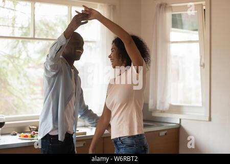 African couple standing in the kitchen dancing feels happy Stock Photo