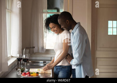 Romantic african american couple cooking healthy food together in ...