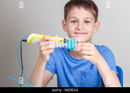 Boy creating with 3 d pen Stock Photo