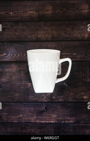 One single coffee mug on wooden table background - 1 java espresso for morning pick me up coffee break with blank empty room for text or copy space. R Stock Photo