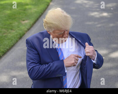 Washington, District of Columbia, USA. 2nd Aug, 2019. United States President Donald J. Trump gestures to his inside suit pocket as he tells the press about his short list of three individuals to be the director of national intelligence as he speaks to the media prior to departing the South Lawn of the White House in Washington, DC for a weekend trip to the Trump National Golf Club in Bedminster, New Jersey on Friday, August 2, 2019 Credit: Ron Sachs/CNP/ZUMA Wire/Alamy Live News Stock Photo