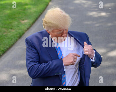 Washington, United States Of America. 02nd Aug, 2019. United States President Donald J. Trump gestures to his inside suit pocket as he tells the press about his short list of three individuals to be the director of national intelligence as he speaks to the media prior to departing the South Lawn of the White House in Washington, DC for a weekend trip to the Trump National Golf Club in Bedminster, New Jersey on Friday, August 2, 2019.Credit: Ron Sachs/CNP | usage worldwide Credit: dpa/Alamy Live News Stock Photo