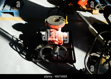 Shallow depth of field image with iron industrial equipment used in the oil and gas drilling industry laid on the ground of a workshop Stock Photo