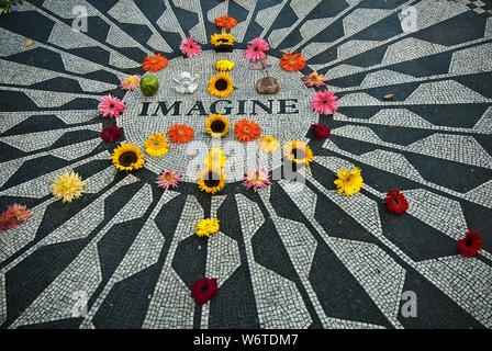 Flowers help form a peace sign in the Imagine mosaic at Strawberry Fields in New York City’s Central Park, a memorial to musician John Lennon. Stock Photo