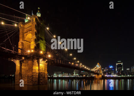 The John A. Roebling Bridge illuminated at night, spanning the Ohio River between downtown Cincinnati, Ohio, and Covington, Kentucky. Stock Photo