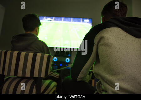 Two teenagers playing video game Stock Photo