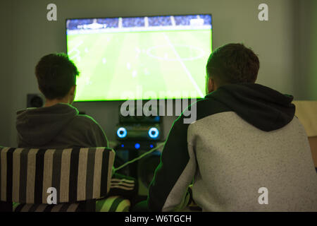 Two teenagers playing video game Stock Photo
