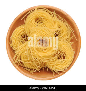 bunches of nested noodle pasta in wooden bowl isolated on white background Stock Photo