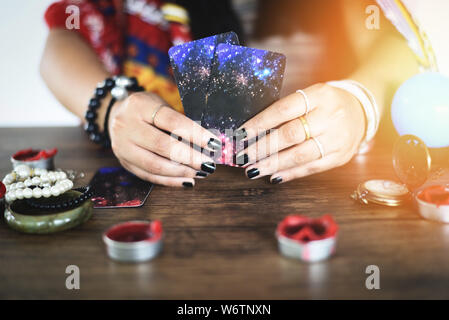 Tarot cards reading divination Psychic readings and clairvoyance concept / Crystal ball fortune teller hands Stock Photo