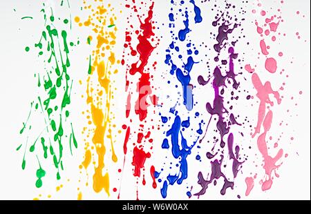 Paintbrushes dripping paint of various colors Stock Photo