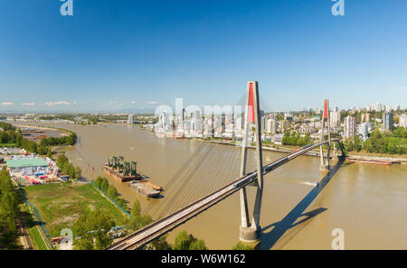 Aerial view of Skytrain Bridge over the Fraser River. Taken in Surrey, Greater Vancouver, British Columbia, Canada. Stock Photo
