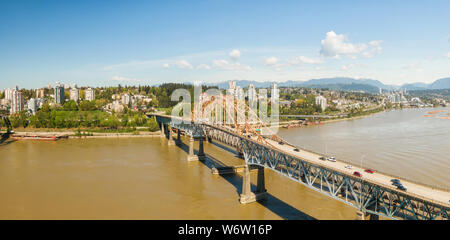 Aerial panoramic view of Pattullo Bridge over the Fraser River. Taken in Surrey, Greater Vancouver, British Columbia, Canada. Stock Photo
