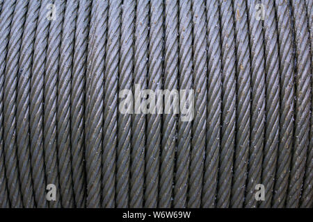 Wire rope sling or cable sling on crane reel drum or winch roll of crane the lifting machine in heavy industrial. steel cable. texture. metal rope Stock Photo