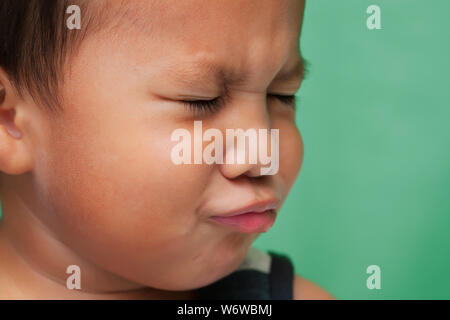 Little kid with facial expression that shows sadness or crying. Stock Photo