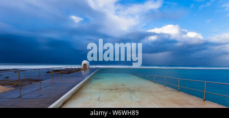 Stormy winters day at Merewether Ocean Baths - Newcastle NSW Australia. These ocean baths are a iconic landmark in the coastal city. Stock Photo