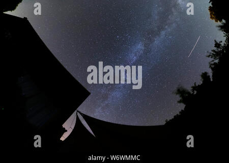 Sablet, The Vaucluse, France. 3rd August 2019. Clear dark skies in southern France show the Milky Way appearing brightly in the night sky with a bright satellite trail running parallel to the galactic plane. Credit: Malcolm Park/Alamy Live News. Stock Photo