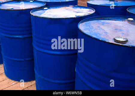 colored metal barrels. Blue oil drums containing fuel for transportation. Stock Photo