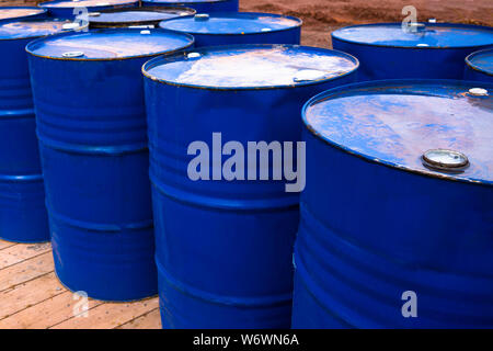 colored metal barrels. Blue oil drums containing fuel for transportation. Stock Photo