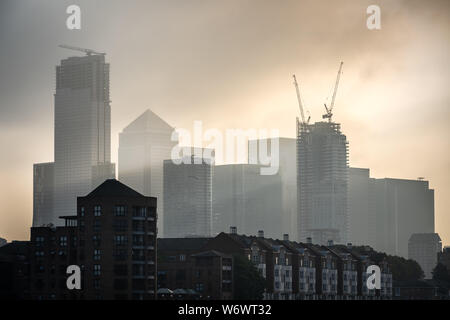 London, UK. 2nd August, 2019. UK Weather: Dramatic morning light breaks over Canary Wharf business park buildings - seen from Greenland Dock, Surrey Quays. Credit: Guy Corbishley/Alamy Live News Stock Photo