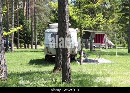 An old little caravan in the woods Stock Photo