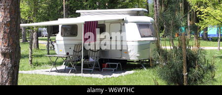 An old little caravan in the woods Stock Photo