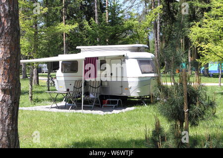 An old little caravan in the woods Stock Photo