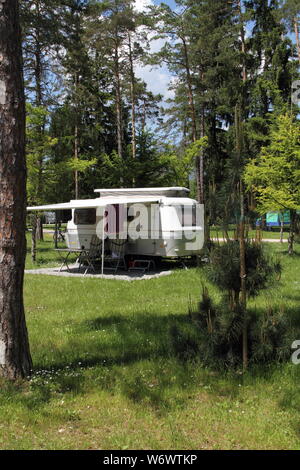 An old little caravan in the woods Stock Photo