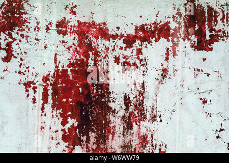 Old white concrete wall stained with red paint. Design texture for house interior or wallpapers. Stock Photo