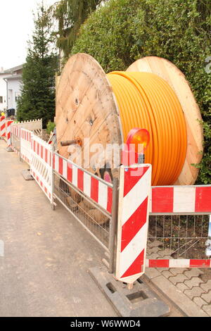 orange fiber optic cable on the street Stock Photo