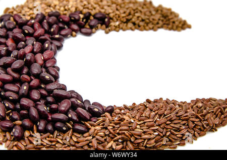 red beans, brown ruby rice and buckwheat on a white background with copy space Stock Photo