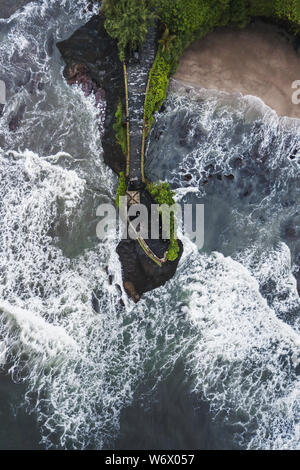 Aerial view of famous balinese temple Tanah Lot in stormy weather with huge crashing waves. Top Indonesian landmark Stock Photo