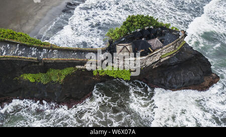 Aerial view of famous balinese temple Tanah Lot in stormy weather with huge crashing waves. Top Indonesian landmark Stock Photo